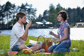 Image showing happy young couple having a picnic outdoor