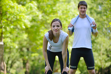 Image showing Couple doing stretching exercise  after jogging