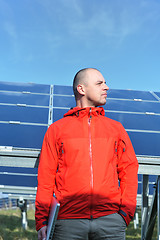 Image showing engineer using laptop at solar panels plant field