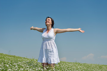 Image showing Young happy woman in green field