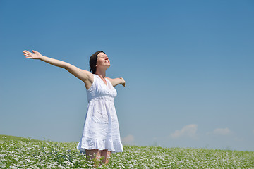 Image showing Young happy woman in green field