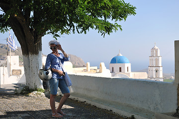 Image showing Greek woman on the streets of Oia, Santorini, Greece