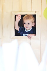 Image showing happy child in a window