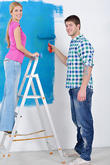 Image showing happy couple paint wall at new home