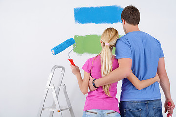 Image showing happy couple paint wall at new home