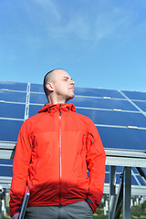 Image showing engineer using laptop at solar panels plant field