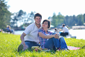 Image showing happy young couple having a picnic outdoor