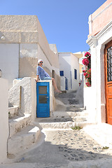 Image showing Greek woman on the streets of Oia, Santorini, Greece