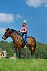 Image showing happy woman  ride  horse