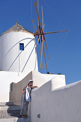 Image showing Greek woman on the streets of Oia, Santorini, Greece