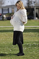 Image showing happy young pregnant woman outdoor