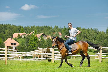 Image showing man ride horse