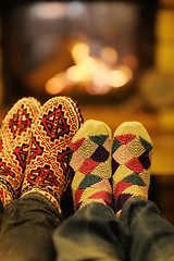 Image showing Young romantic couple sitting and relaxing in front of fireplace