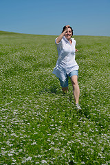 Image showing Young happy woman in green field