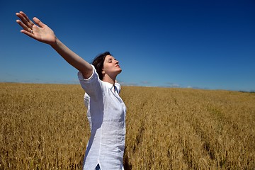 Image showing young woman in wheat field at summer