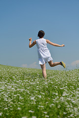 Image showing Young happy woman in green field