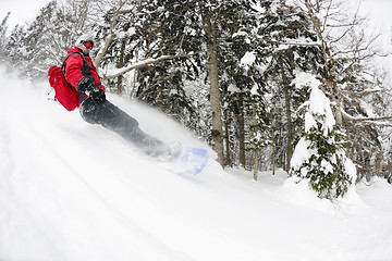 Image showing snowboarder on fresh deep snow