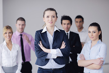 Image showing business woman standing with her staff in background