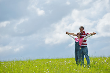 Image showing Portrait of romantic young couple smiling together outdoor