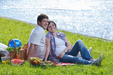 Image showing happy young couple having a picnic outdoor