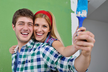 Image showing happy couple paint wall at new home