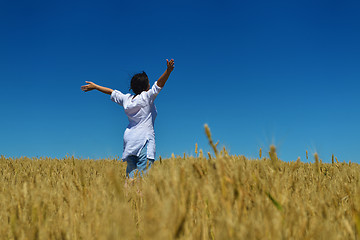 Image showing young woman in wheat field at summer