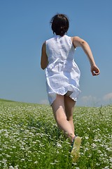 Image showing Young happy woman in green field