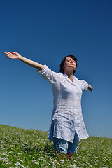 Image showing Young happy woman in green field