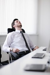 Image showing tired and depresed young business man at office