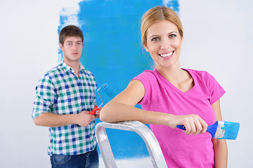 Image showing happy couple paint wall at new home