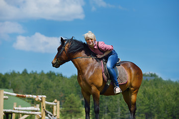 Image showing happy woman  ride  horse