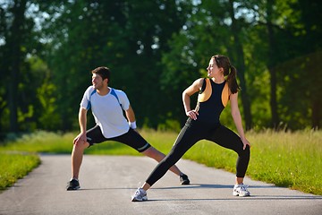 Image showing Couple doing stretching exercise  after jogging