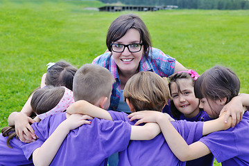 Image showing happy kids group with teacher in nature