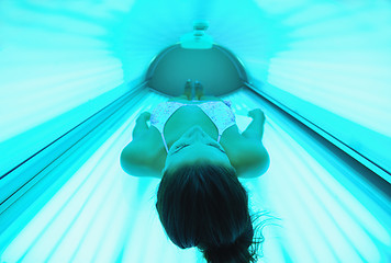 Image showing Beautiful young woman tanning in solarium