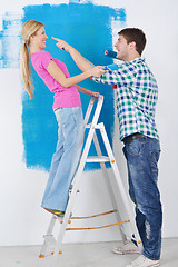 Image showing happy couple paint wall at new home