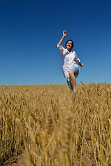 Image showing young woman in wheat field at summer