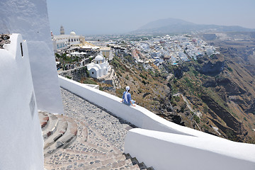 Image showing Greek woman on the streets of Oia, Santorini, Greece