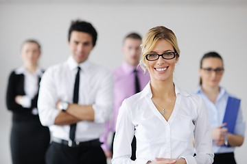 Image showing business woman standing with her staff in background