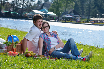 Image showing happy young couple having a picnic outdoor