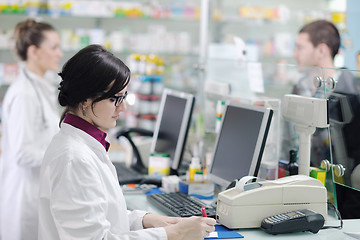 Image showing pharmacist suggesting medical drug to buyer in pharmacy drugstor