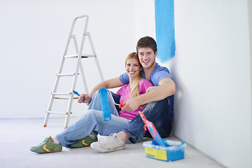 Image showing happy young cople relaxing after painting in new home