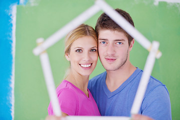 Image showing happy couple paint wall at new home