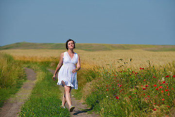 Image showing young woman in wheat field at summer