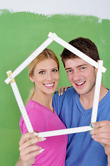 Image showing happy couple paint wall at new home