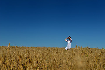 Image showing young woman in wheat field at summer