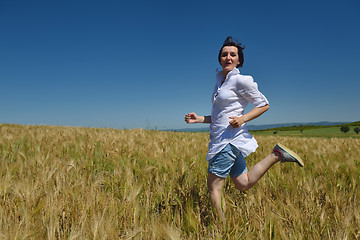 Image showing young woman in wheat field at summer