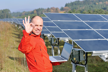 Image showing engineer using laptop at solar panels plant field