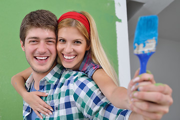 Image showing happy couple paint wall at new home