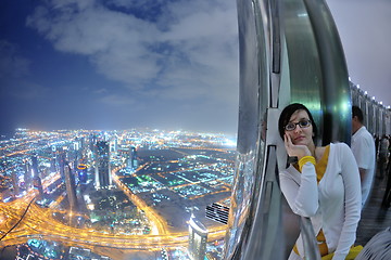 Image showing beautiful woman portrait with big city at night in background