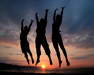 Image showing Three people jumping